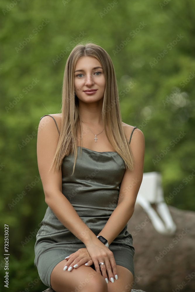 Portrait of a young beautiful blonde girl in a city summer park. Portrait of a young beautiful blonde girl in a city summer park.