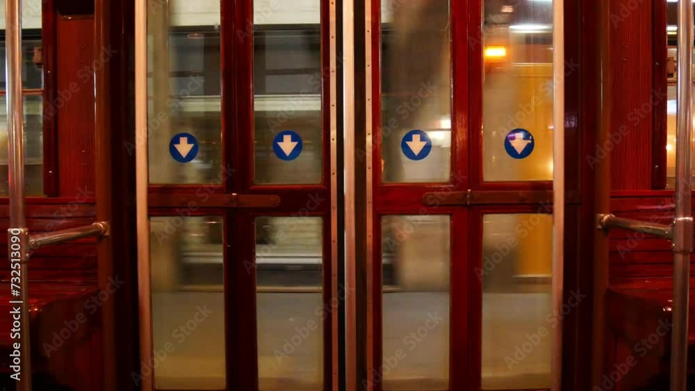 Internal automatic exit door of the moving tram in Milan, Italy by night Internal automatic exit door of the moving tram in Milan, Italy by night
