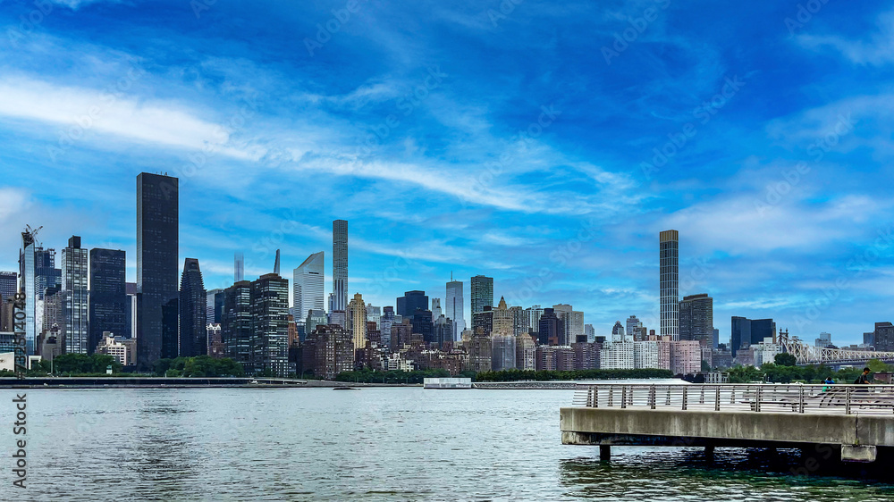 Enjoying the New York skyline from the rock cliff pier and viewpoint of Long Island which is a large island that extends from the east of the Big Apple and Manhattan (USA).