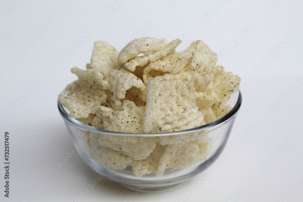 Crackers in net shape, in transparent glass bowl. isolated on white background Crackers in net shape, in transparent glass bowl. isolated on white background