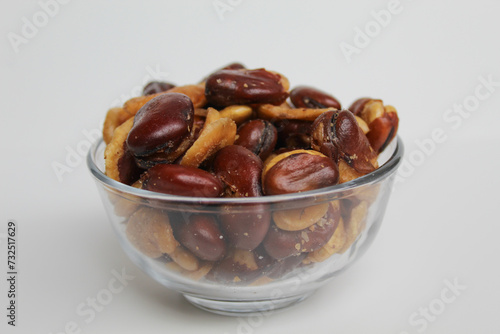 Kacang koro, or cooked jack bean, in a transparent glass bowl, isolated on white background