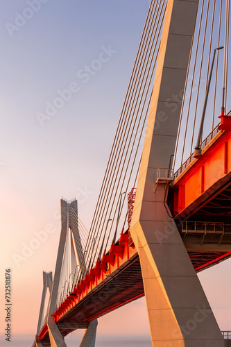 Cable-stayed bridge in the light of the morning sun and against the background of a clear blue sky. Moore. Russia.