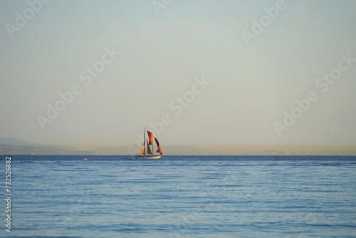 sailboat on the Atlantic Ocean seen from the beach in Andalusia, mountains of Morocco at the horizon, Spain, Europe, boat, ship, nautical
