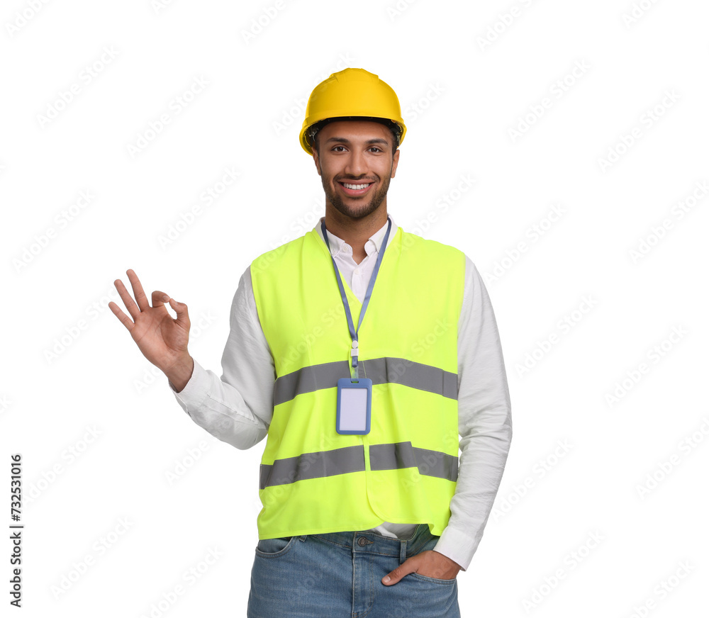 Engineer with hard hat and badge showing ok gesture on white background Engineer with hard hat and badge showing ok gesture on white background