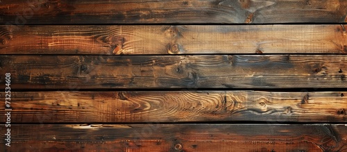 A detailed view of a brown wooden wall showcasing a row of rectangular hardwood planks with a beautiful wood grain pattern.
