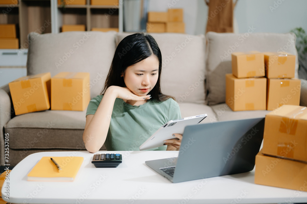Small business entrepreneur SME freelance woman working at home office, BOX,tablet and laptop online, marketing, packaging, delivery Small business entrepreneur SME freelance woman working at home office, BOX,tablet and laptop online, marketing, packaging, delivery