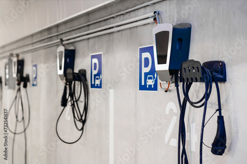 Fotografía Electric Vehicle Charging Station in Private Garage Parking lot of Multifamily Building with Numbers and Control Panels