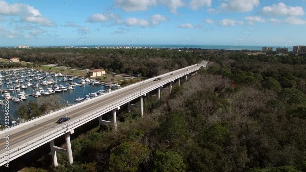 Aerial Lockdown Time Lapse Shot Of Bridge By Nautical Vessels In Sea At Harbor On Sunny Day - Daytona Beach , Florida Aerial Lockdown Time Lapse Shot Of Bridge By Nautical Vessels In Sea At Harbor On Sunny Day - Daytona Beach , Florida