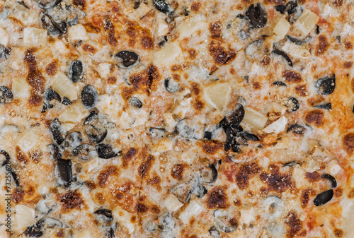 Top view of pieces of ingredients in fresh hot delicious pizza. Close-up photography of food.