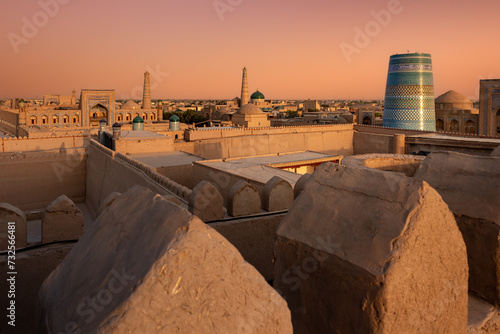 Old city aerial view with Kalta Minor, madrasah and ancient city wall at sunset, Khiva, Uzbekistan photo