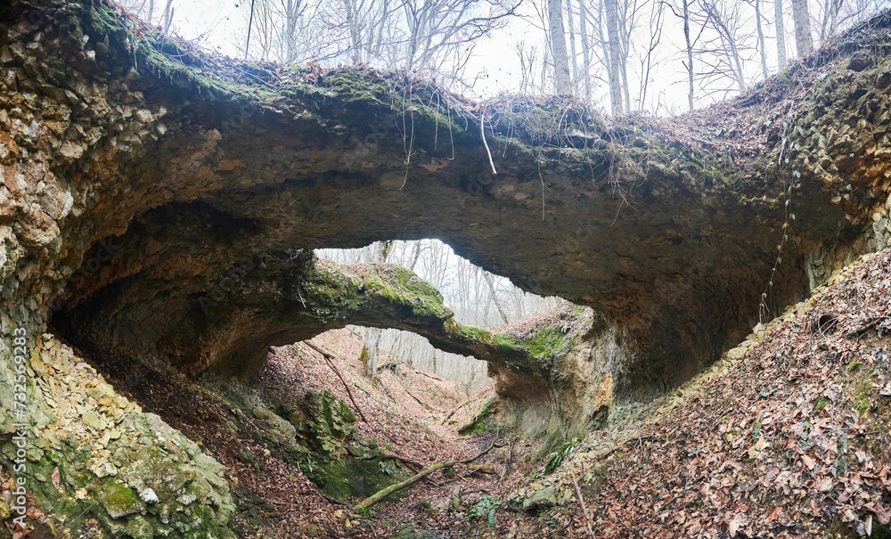 A unique natural phenomenon in the form of a stone bridge. The time of year is autumn or winter. A unique natural phenomenon in the form of a stone bridge. The time of year is autumn or winter.