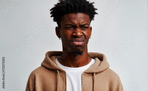 Portrait of an African American man whose facial expression expresses disgust and hostility. photo