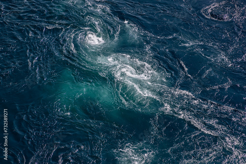 The deep blue of Saltstraumen whirlpool waters is accentuated by the vigorous dance of tidal currents, offering a breathtaking texture and color palette photo