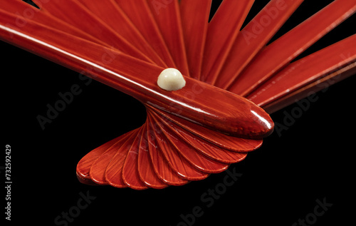 Japanese traditional hand fan from bamboo and paper or silk isolated on black