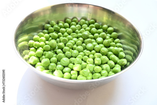 Fresh green pea on white background. There is a lot of vitamins  and Minerals in it. The pea is most commonly the small spherical seed or the seed. Popular vegetable of all over world.  © SUBASCHANDRA