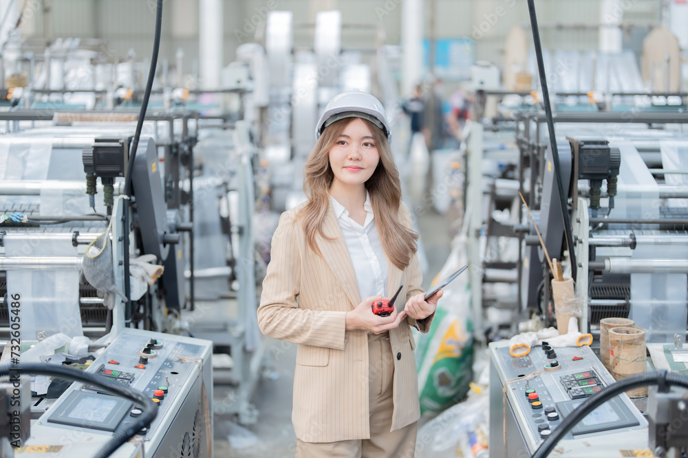 The female presenter is an Asian engineer. Owners of factories and export businesses, plastic and steel companies, stand smart near working machinery, producing products for export to the world market