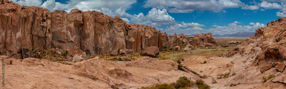 Obraz premium Laguna Catal, a stunning lake surrounded by eroded lava boulders, populated by herds of semi-wild llamas, Bolivia