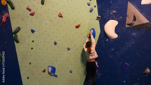 YOUNG GIRL OR YEENAGER CLIMBING IN A BLOCK ROOM time-lapse video photo