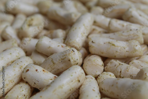 Fish crackers in small cylinder shape. Snack from Indonesia, called krupuk ikan tongkol. Flat lay or top view photo