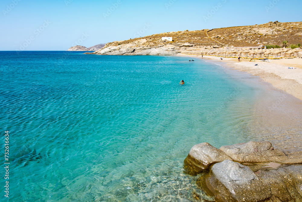 Lia Beach, wild and free beach in the south of Mykonos, Greece. Pristine bay with blue sea and crystal water, famous for naturism and Scuba diving school, peaceful and quiet.