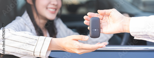 Business car rental, sell or buy service, dealership hand of agent dealer, sale young woman giving auto key of vehicle to customer renter, buyer man receiving, client or tenant, transfer automobile.