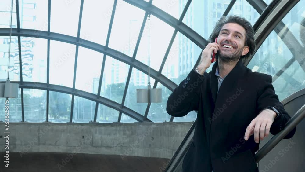 View of young man using a smartphone at twilight in an indoor space with a blurred view landscape in the background. High quality video. Texting , talking on the phone. View of young man using a smartphone at twilight in an indoor space with a blurred view landscape in the background. High quality video. Texting , talking on the phone.