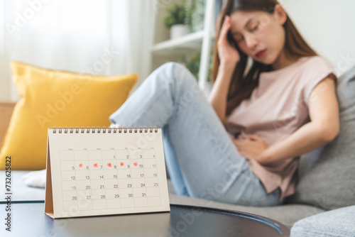 Menstruation, period cycle day of monthly, hurt asian young woman, female hand in stomach ache, suffer from PMS premenstrual, belly or abdomen pain on bed at home. Health problem Inflammation in body.