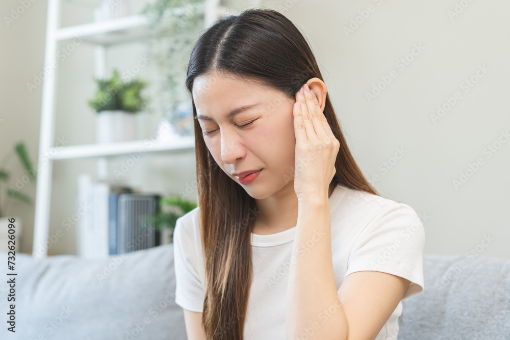 Tinnitus concept, sick asian young woman, girl have ear pain or earache, hand touch plug ear, suffering painful otitis from loud of noisy sound, inflammation. Health care nerve deaf eardrum disease. Tinnitus concept, sick asian young woman, girl have ear pain or earache, hand touch plug ear, suffering painful otitis from loud of noisy sound, inflammation. Health care nerve deaf eardrum disease.