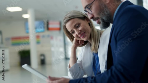 Pharmaceutical sales representative talking with doctor in medical building. Female doctor talking with hospital director, manager in private clinic.