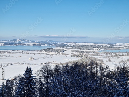 Panoramic landscape aerial view in Bavaria. Rieden on Forggensee lake and deep snow at winter time.