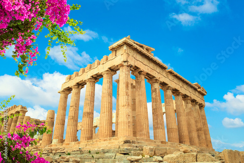 Parthenon temple, Acropolis hill, Athens Greece over beautiful blue sky and flowers