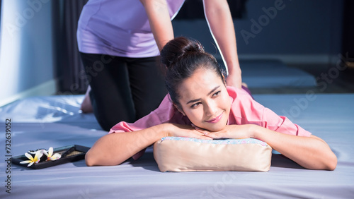 Thai back massage on bed by professional masseuse