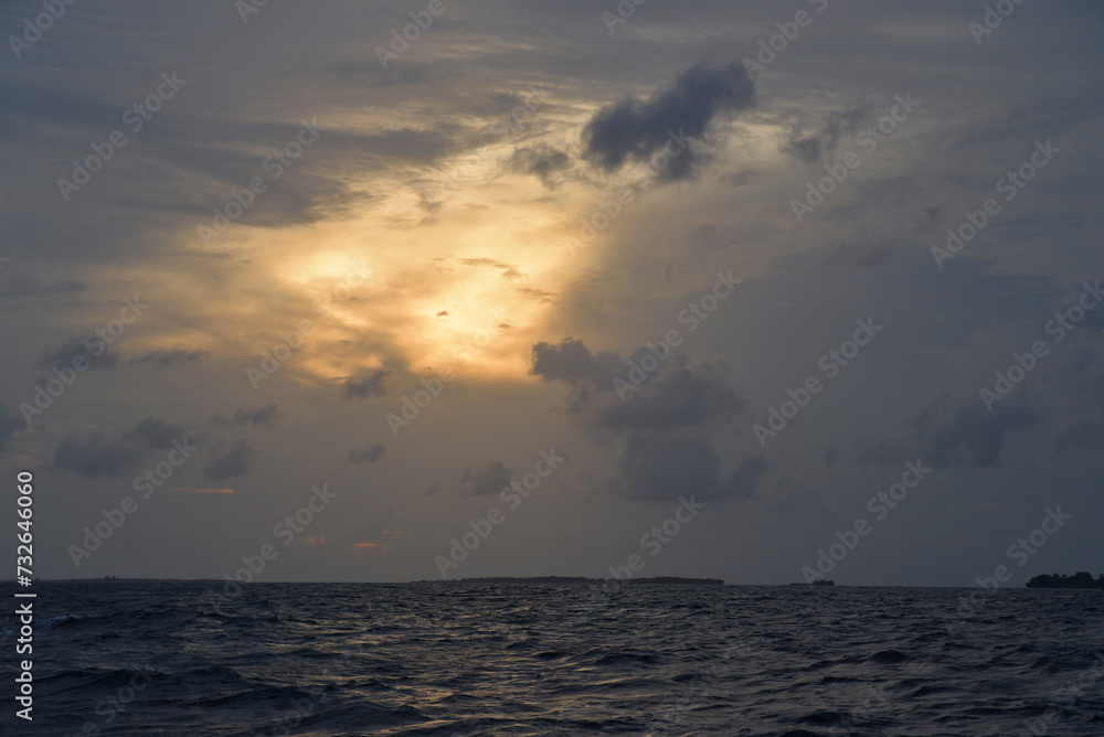 Picturesque sunset on the Maldivian island. Ocean view from a boat Picturesque sunset on the Maldivian island. Ocean view from a boat