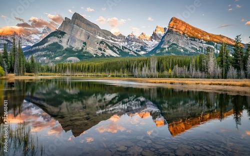 Three sisters mountains of rocky mountains reflection on bow river in the morning at Canmore, Banff national park photo