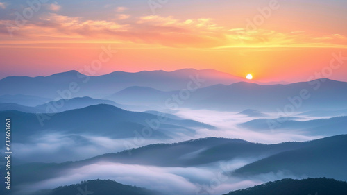 The sun over a majestic mountain blue range. Misty nature background.