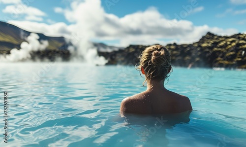 Icelandic Geothermal Bliss: Happy Tourist Woman Immerses in Relaxation, Enjoying the Tranquil Blue Lagoon and the Natural Beauty of Iceland's Geothermal Wonders.   © Mr. Bolota
