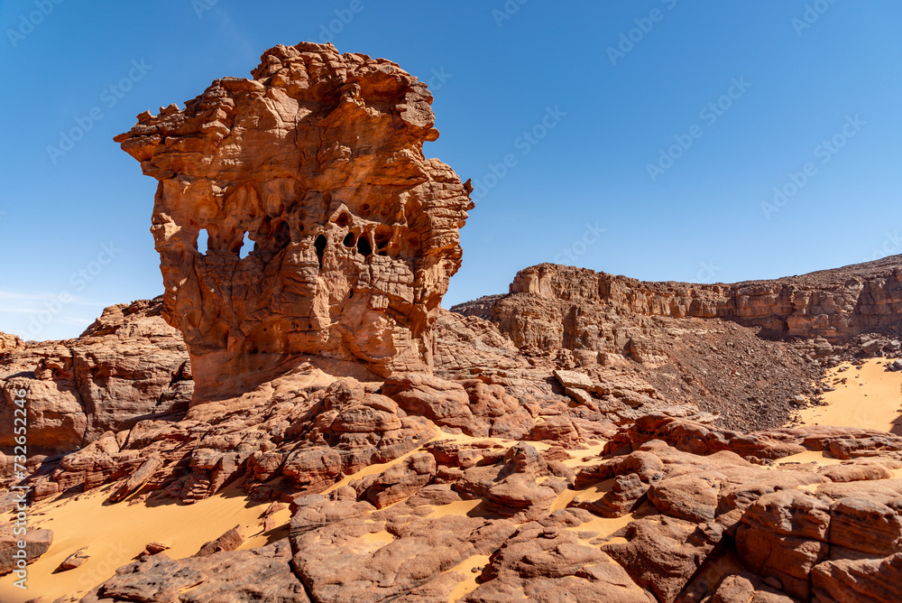 Tadrart landscape in the Sahara desert, Algeria. A curious rock formation in red sandstone where some sort of windows appear