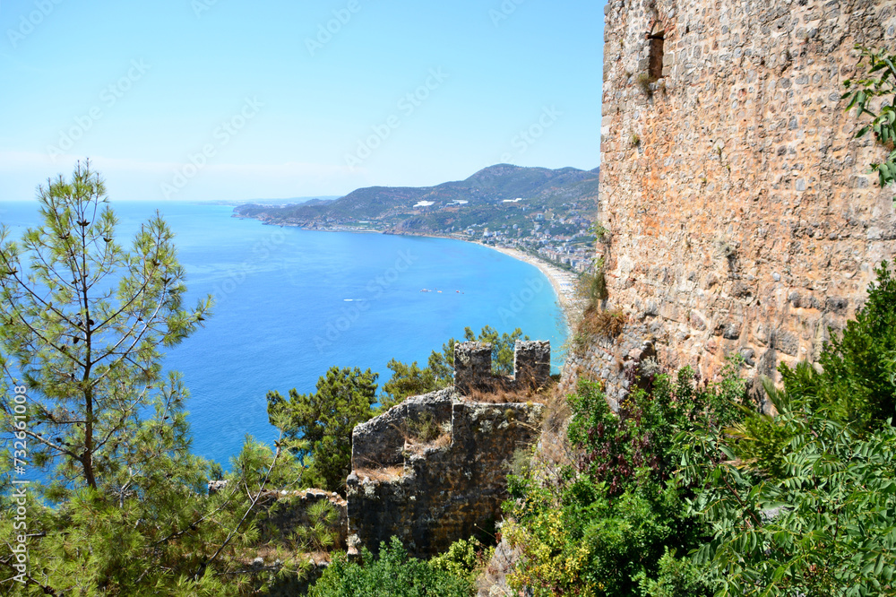 brick wall of ancient fortress with blue sea on background copy space 
