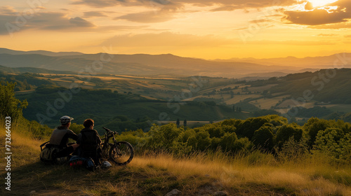 Cyclists at Rest on Hilltop Overlooking Panoramic View of Rolling Hills at Sunset, Peaceful Landscape, Travel and Adventure, Biking Break with Scenic Vista, Serenity of Nature, Outdoor Recreation