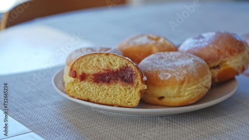 Sweet Delicious Traditional Polish Glazed Doughnut Paczek Filled with Sweet Jam Marmalade Prepared for Dessert on Fat Thursday Celebration before Ash Wednesday and Lent