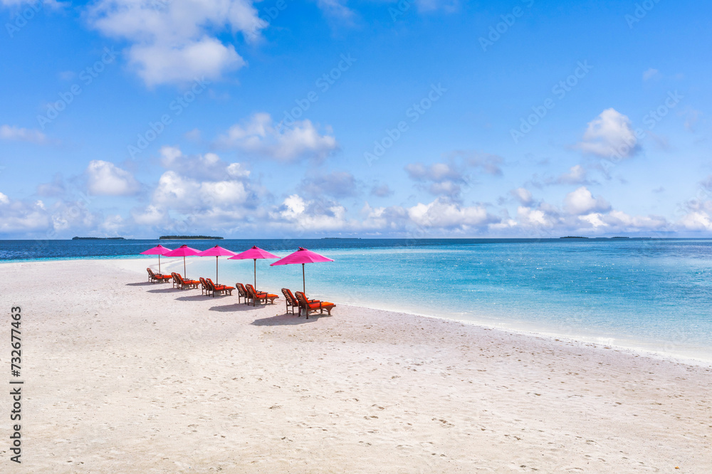 Aerial view of amazing beach with umbrellas and lounge chairs beds close to turquoise sea. Top view of summer beach landscape, idyllic inspire couple vacation, romantic holiday. Freedom travel tourism