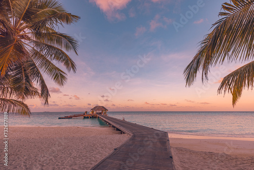 Fototapeta Naklejka Na Ścianę i Meble -  Amazing beach landscape. Beautiful Maldives sunset seascape view. Horizon colorful sea sky clouds, over water villa pier pathway. Tranquil island lagoon, tourism travel background. Exotic vacation