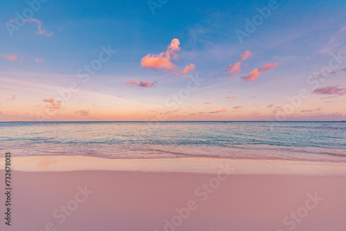 Beachfront sunset. Beautiful panoramic landscape, colorful golden sunlight over calm sea waves splashing softly on idyllic sandy beach. Amazing sunrise landscape, summer nature, peaceful morning coast © icemanphotos