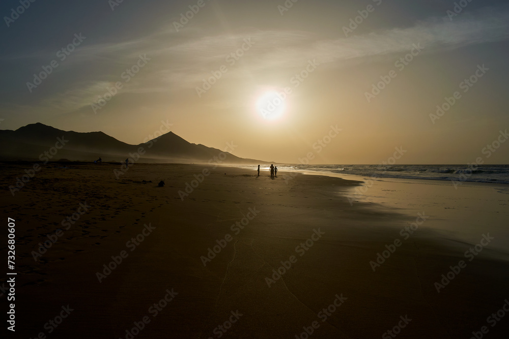 Sunset on Cofete beach in Fuerteventura in Jandia Natural Park with silhouettes and mountains
