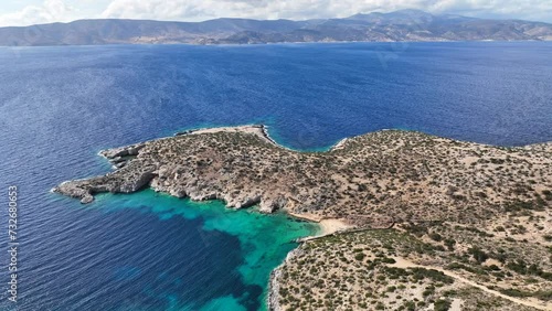 Aerial drone video of paradise beach and caves of Gerolimnionas in North part of small island of Schoinousa, Small Cyclades, Greece photo