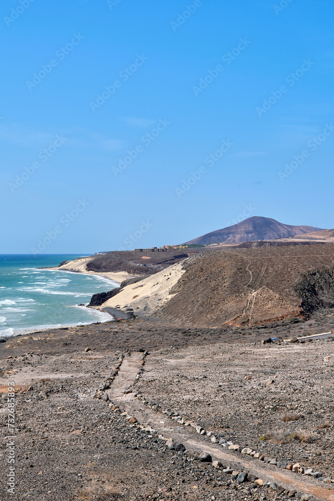 The Atlantic Ocean and Sotavento beach with clear sky and mountains in back