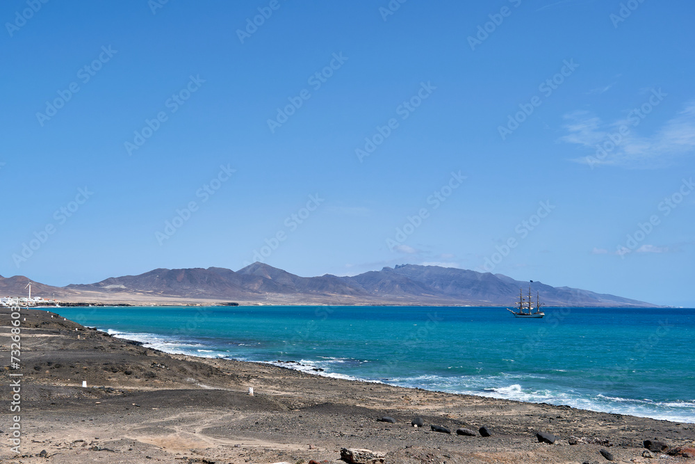 Ship near the Jandia lighthouse in Fuerteventura Spain Ship near the Jandia lighthouse in Fuerteventura Spain