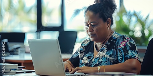 Woman business executive working on laptop computer in a modern office