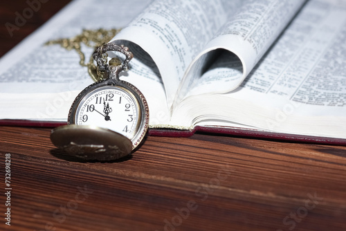 a pocket watch with book background