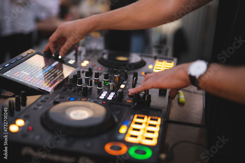 a DJ plays music on a controller at a party